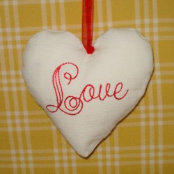 love lettering padded heart hanging ornament made in the machine embroidery hoop lavender filled linen heart needle passion embroidery npe